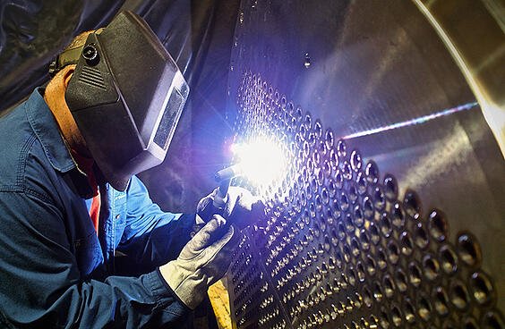TransTech Acquires Bendel Tank & Heat Exchanger - welder working on a heat exchanger